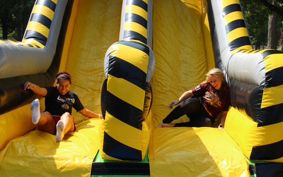 LCC Students play on inflatables