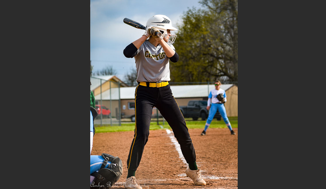 girl up to bat at the plate